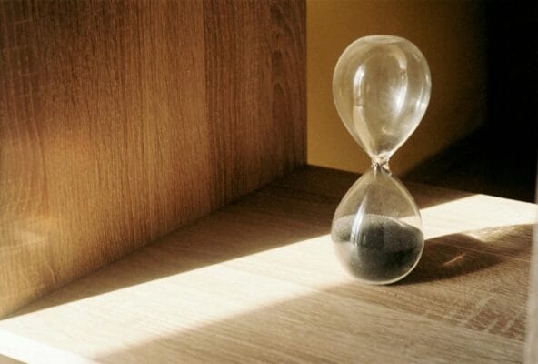 Hourglass with sand representing Epitalon peptide longevity and telomere research