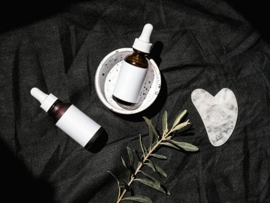 Tretinoin vs retinol — two unbranded skincare serum dropper bottles side by side comparison