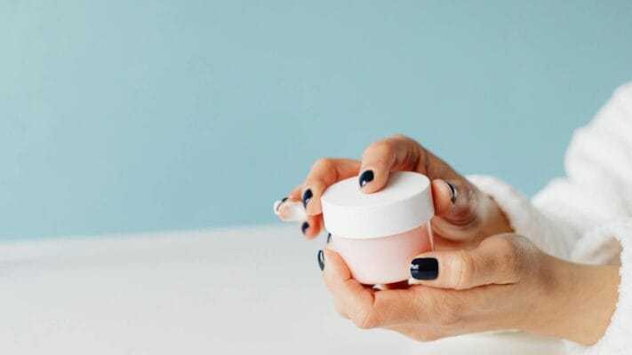 Hands holding skincare cream jar — A-Ret Gel and tretinoin buying guide