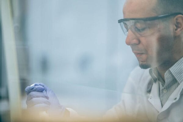 Research scientist with safety glasses in laboratory — GH-axis research