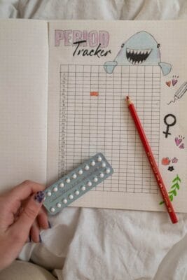 Hand holding birth control pill blister pack — comparison of contraceptive methods