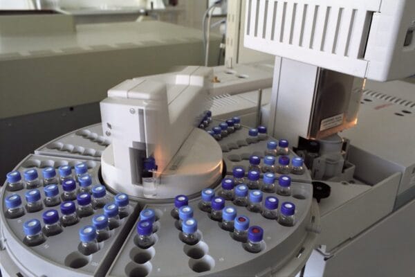 HPLC autosampler carousel loaded with blue-capped research peptide vials — CJC-1295 and ipamorelin