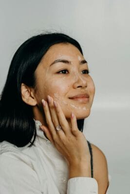 Woman applying face cream for skincare — collagen research