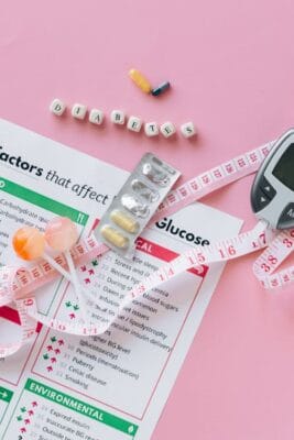 Diabetes pills, glucose meter and treatment leaflet — Glimepiride vs Metformin comparison