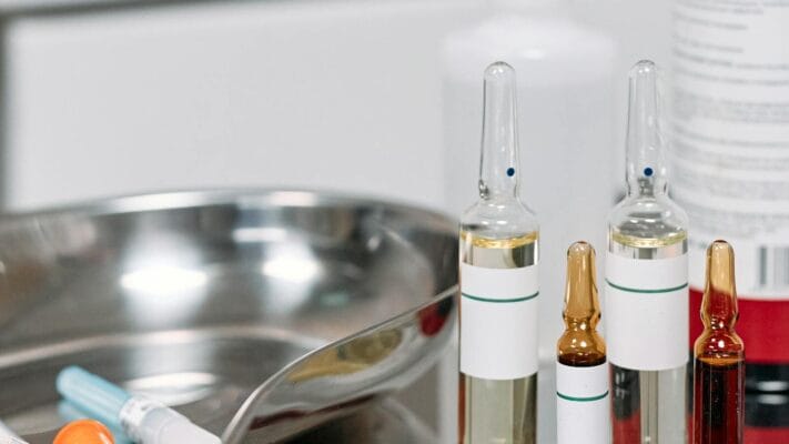 Sterile medical vials and syringes representing HCG injection products