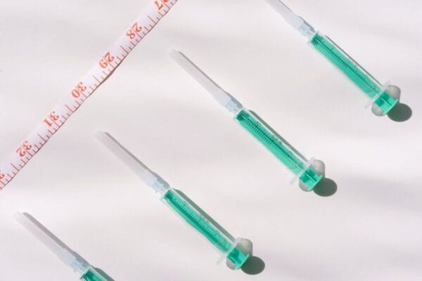 Injection syringes and measuring tape — HCG vs semaglutide for weight loss