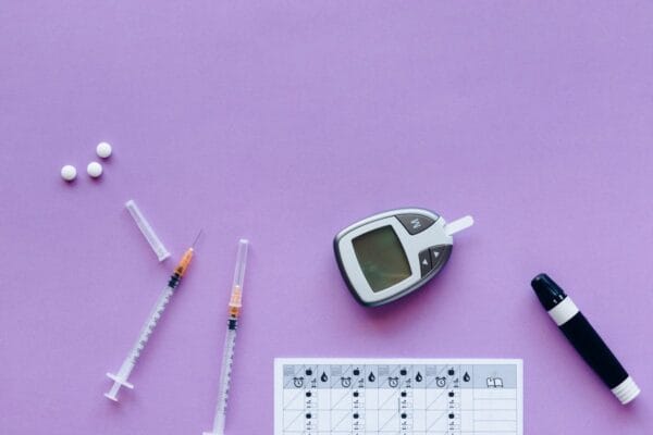 Diabetes management tools including glucometer and pills representing Janumet sitagliptin metformin treatment