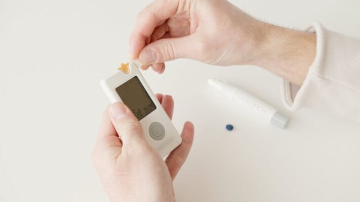Hands holding glucose meter — Jardiance vs metformin type 2 diabetes comparison
