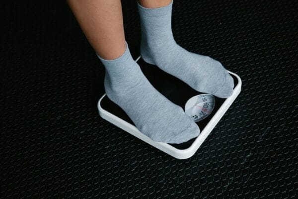 Close-up of feet in socks on scale — metabolic research