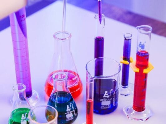 Vivid colored liquids in laboratory glassware — peptide blend research