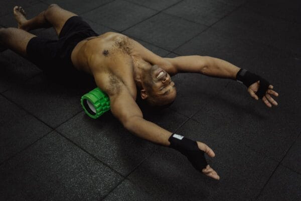 Man using foam roller for muscle recovery representing post cycle therapy