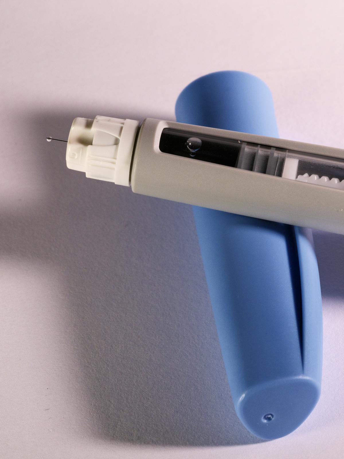 Close-up of semaglutide pen needle tip primed with a small droplet, ready for subcutaneous injection