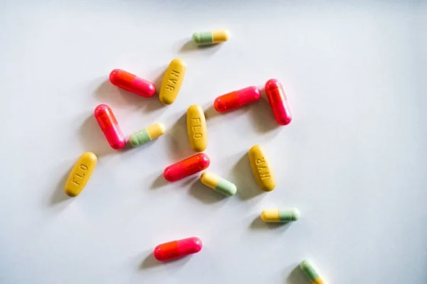 Colourful medication capsules and pills close up