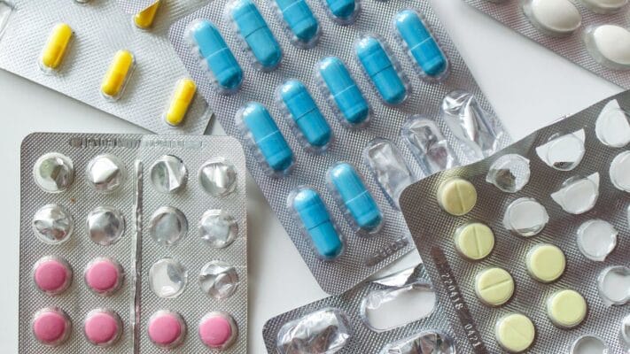 Variety of sildenafil dapoxetine combination tablets in blister packs on white background