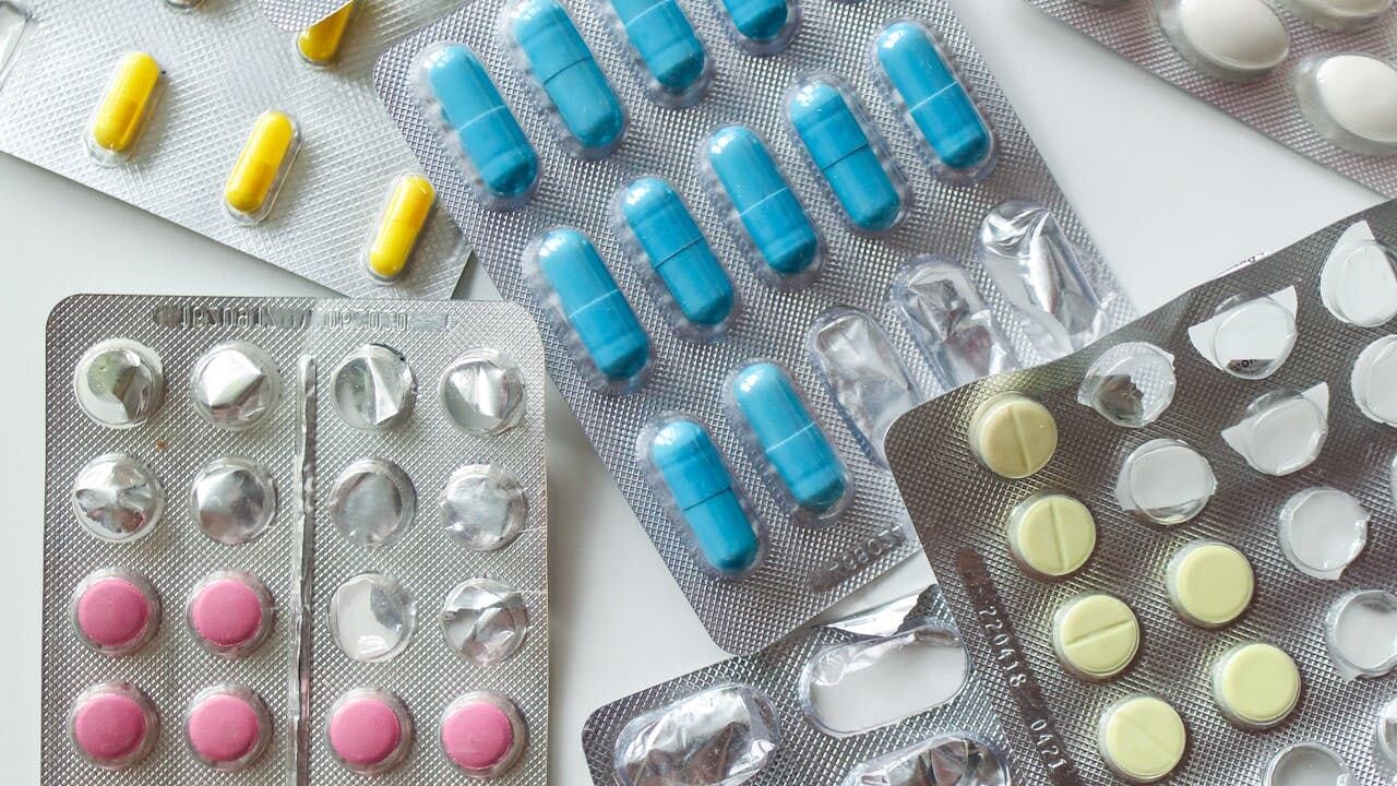 Variety of sildenafil dapoxetine combination tablets in blister packs on white background