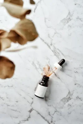 Glass serum bottle with dropper on marble surface — tretinoin strengths guide