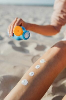 Woman applying sunscreen — tretinoin sun exposure and SPF guide