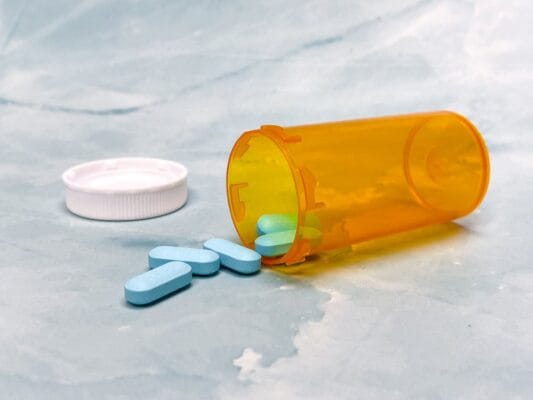 Prescription pills from an orange bottle — Truvada vs Descovy PrEP comparison