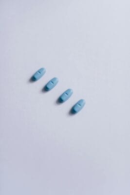 Four blue sildenafil tablets arranged on a neutral white surface — illustrating the generic Viagra molecule discussed in this loss-of-effect guide