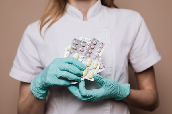 Hands holding birth-control pill blister packs — Yasmin contraceptive pill guide