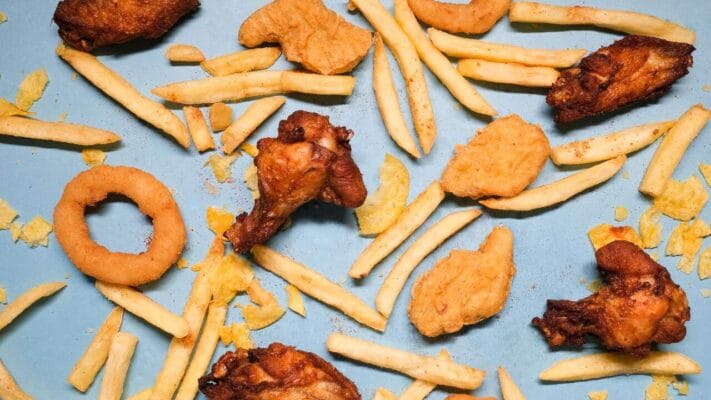 Assortment of fried foods — chicken, fries, nuggets and onion rings — examples of high-fat foods to limit on Trulicity