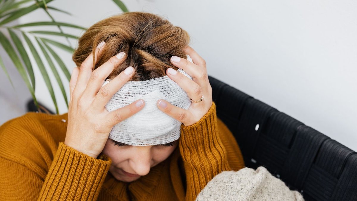 Woman experiencing migraine headache pain, representing need for prevention medication